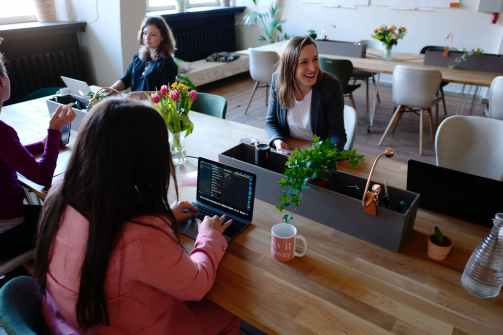woman sitting on the chair using laptop