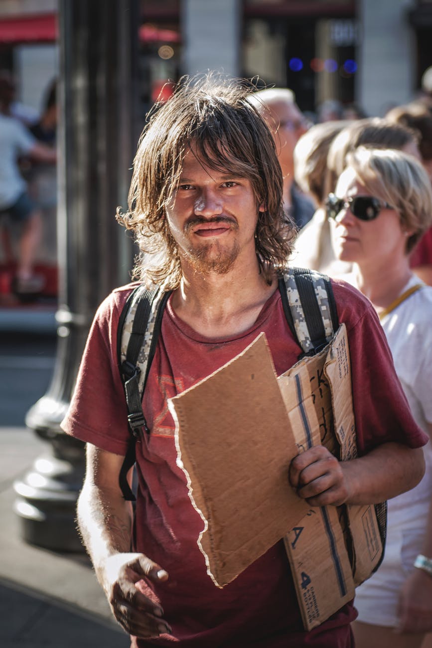 photo of man holding cardboard