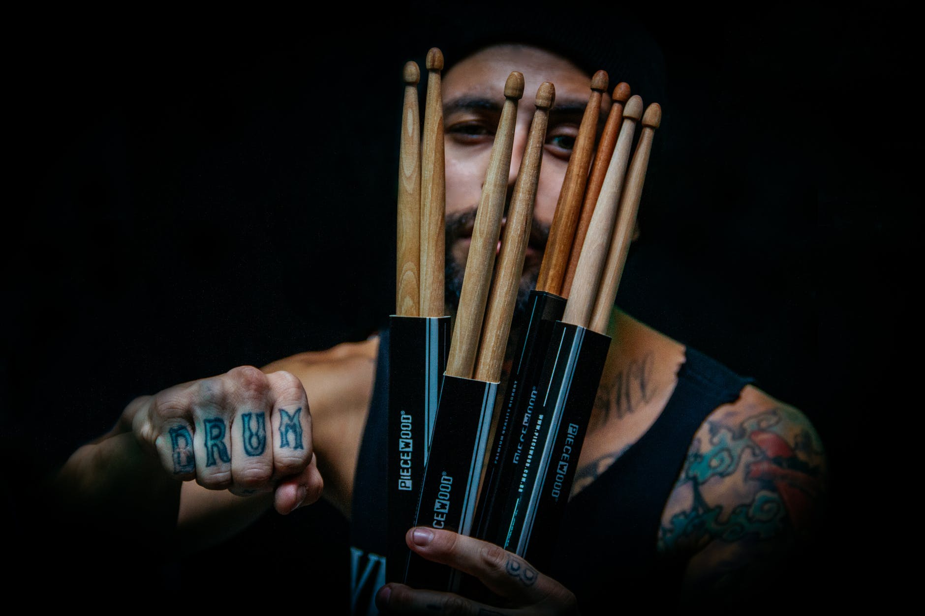 man holding drum sticks
