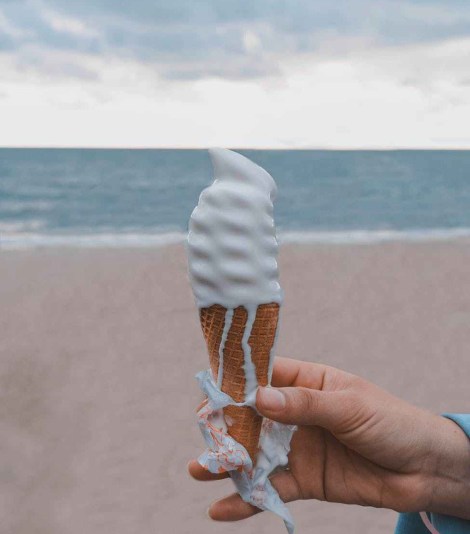 person holding vanilla ice cream on cone